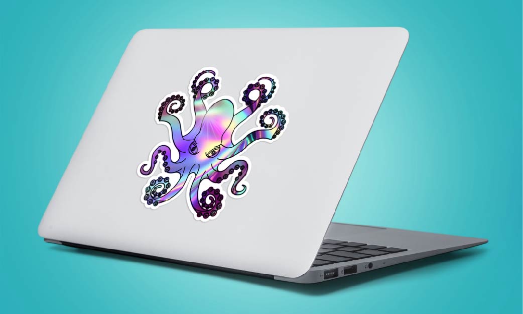 Holographic octopus sticker on back of gray laptop with teal backdrop
