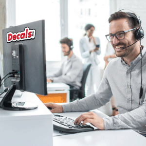 Decals.com Representative on computer and headset phone