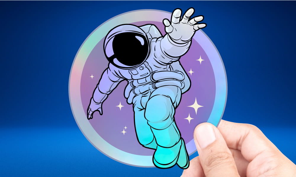 Hand holding an astronaut holographic sticker