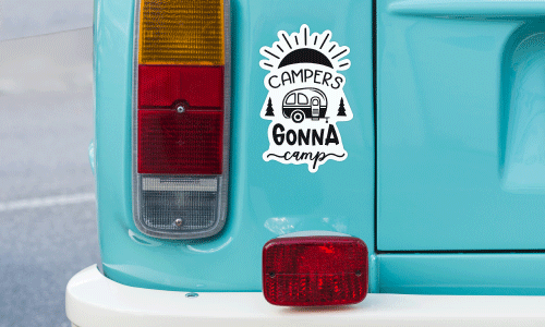 White and black decal that says Campers Gonna Camp placed on a teal camper bumper