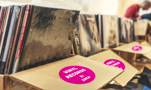 Pink garage sale sticker on vinyl record jacket