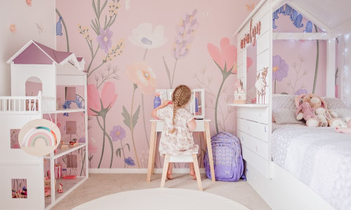 Pink and purple flower wallpaper in a little girls bedroom